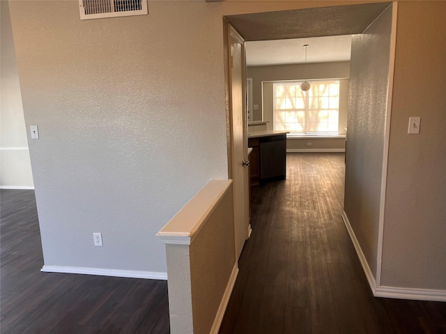 corridor featuring dark wood-type flooring