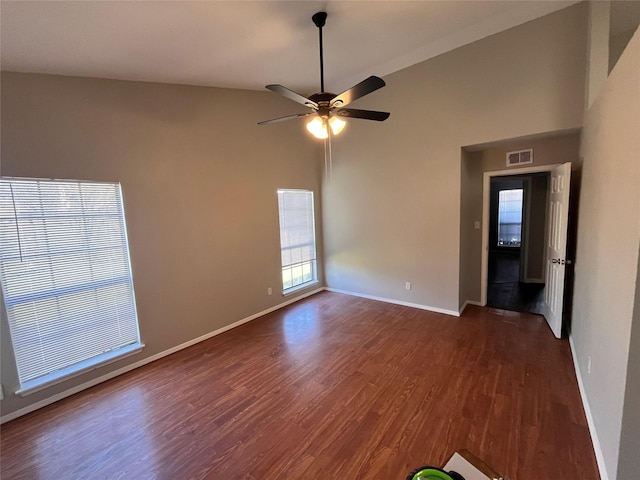 empty room with ceiling fan and dark hardwood / wood-style floors