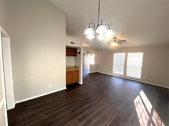 unfurnished living room featuring ceiling fan with notable chandelier, dark wood-type flooring, and vaulted ceiling