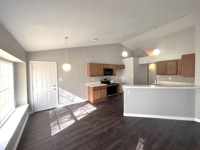 kitchen featuring electric range, dark hardwood / wood-style floors, lofted ceiling, and hanging light fixtures