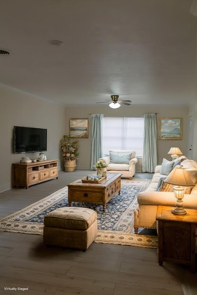 living room featuring hardwood / wood-style floors, ornamental molding, and ceiling fan