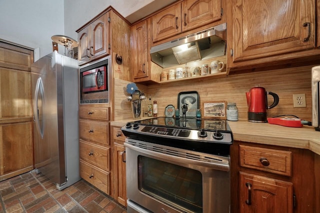 kitchen featuring appliances with stainless steel finishes and tasteful backsplash