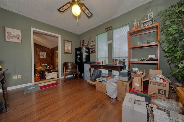 miscellaneous room with ceiling fan, wood-type flooring, and a textured ceiling