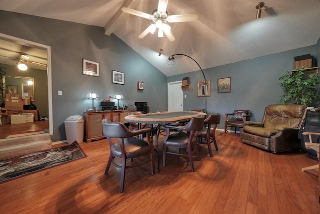 dining space featuring vaulted ceiling with beams, ceiling fan, a textured ceiling, and hardwood / wood-style flooring