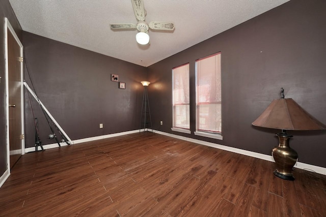 unfurnished room featuring ceiling fan, wood-type flooring, and a textured ceiling