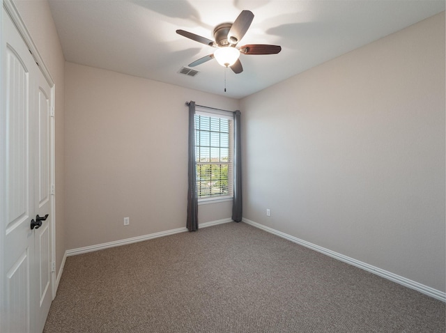 carpeted empty room with ceiling fan