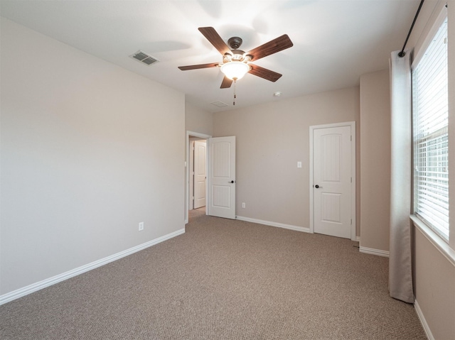 unfurnished bedroom with ceiling fan and light carpet