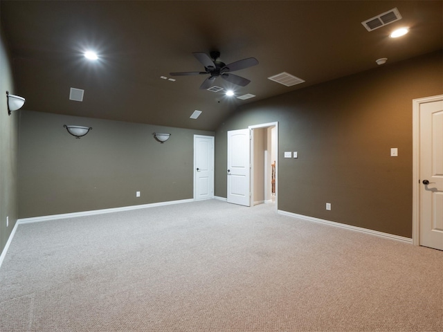 carpeted empty room featuring ceiling fan and vaulted ceiling