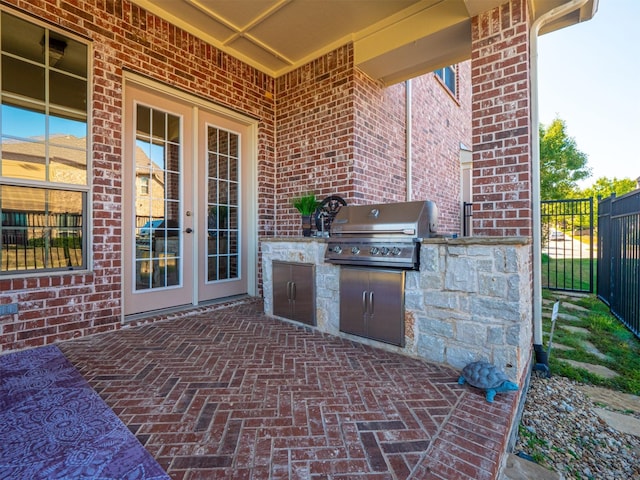 view of patio with french doors, an outdoor kitchen, and area for grilling