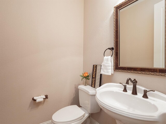 bathroom with toilet and sink