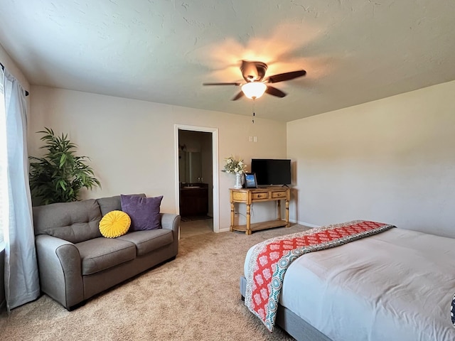 carpeted bedroom featuring ensuite bathroom and ceiling fan