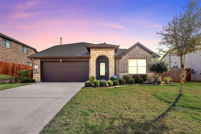 view of front of home featuring a yard and a garage