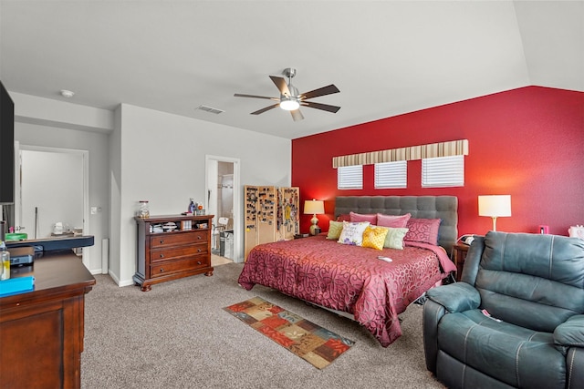 bedroom featuring carpet floors, ensuite bathroom, ceiling fan, and vaulted ceiling