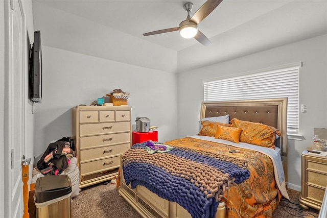 bedroom featuring ceiling fan and dark colored carpet