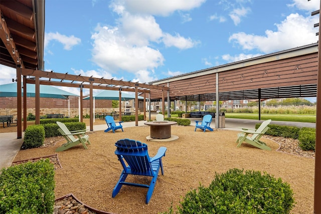 view of property's community with a pergola and a fire pit