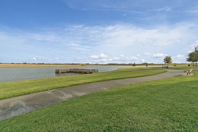 view of property's community featuring a water view and a lawn