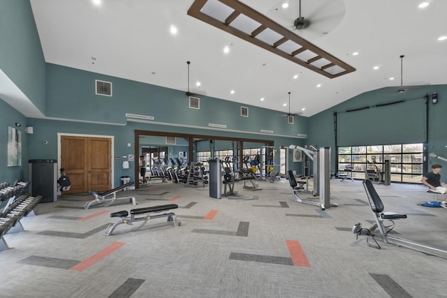 gym featuring ceiling fan, light carpet, and high vaulted ceiling