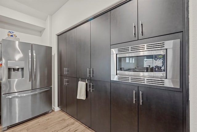 kitchen with stainless steel appliances and light hardwood / wood-style floors