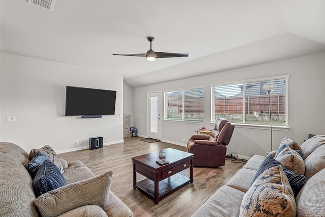 living room featuring ceiling fan, plenty of natural light, and vaulted ceiling