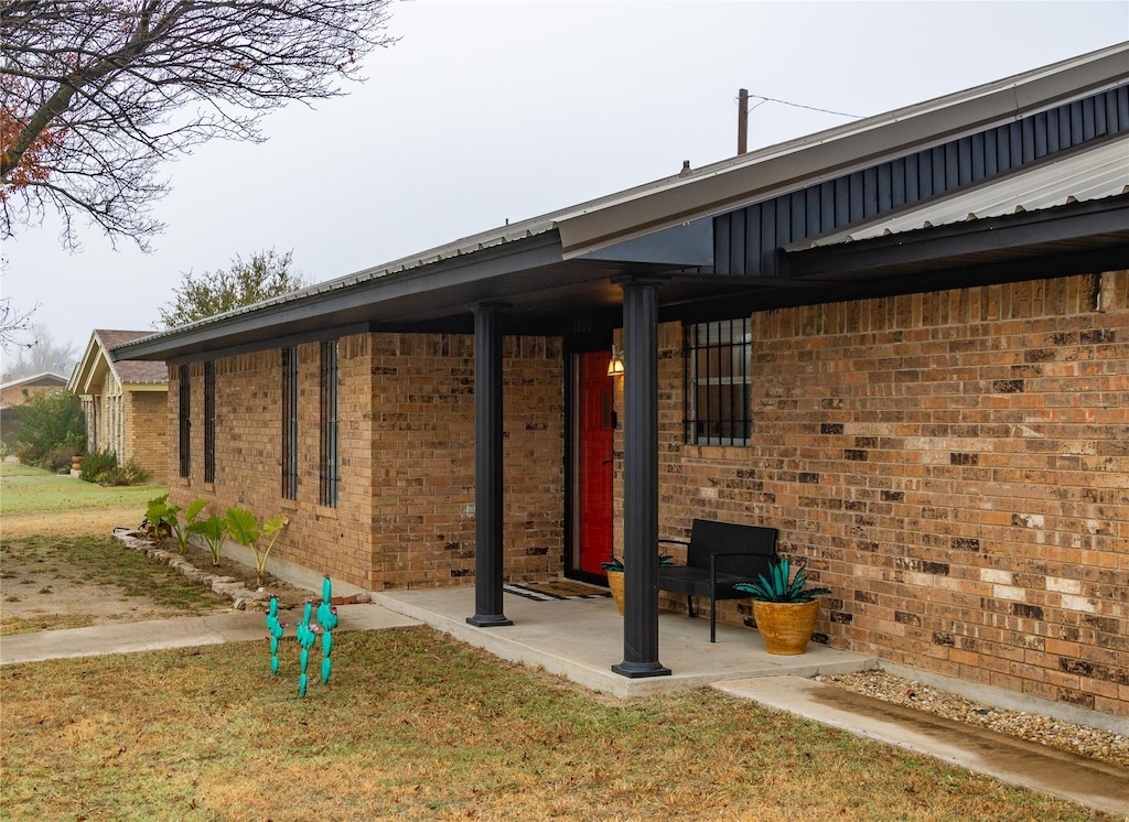 exterior space with a patio and a lawn