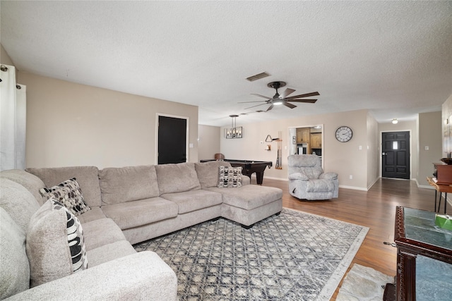 living room featuring ceiling fan, wood-type flooring, a textured ceiling, and pool table