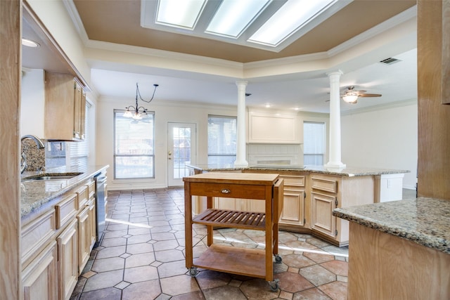 kitchen with tasteful backsplash, dishwasher, sink, and light brown cabinets