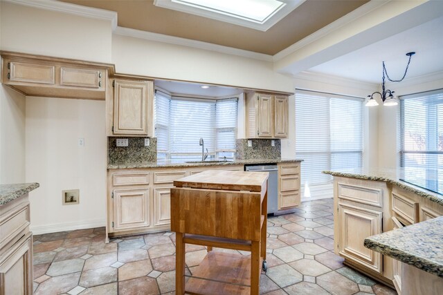 kitchen featuring light brown cabinets, backsplash, sink, light stone countertops, and stainless steel appliances