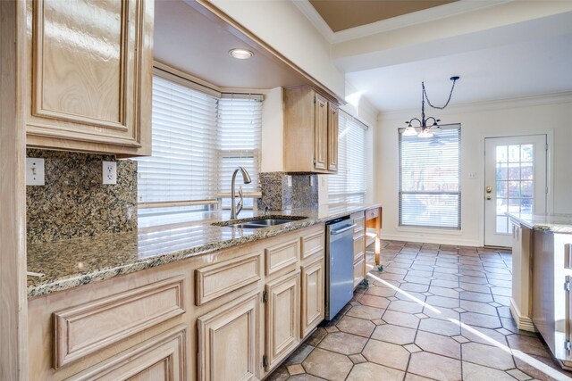 kitchen with light stone countertops, hanging light fixtures, a kitchen island, ceiling fan with notable chandelier, and ornamental molding