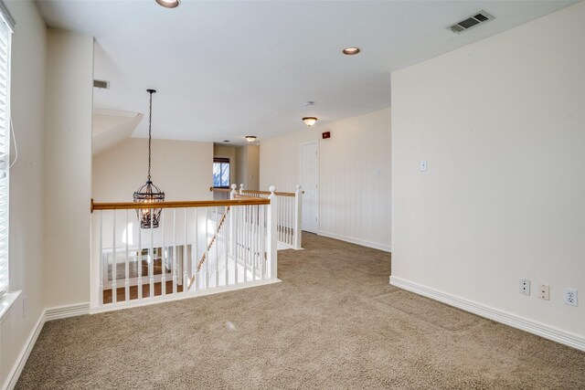 unfurnished room with built in shelves and carpet