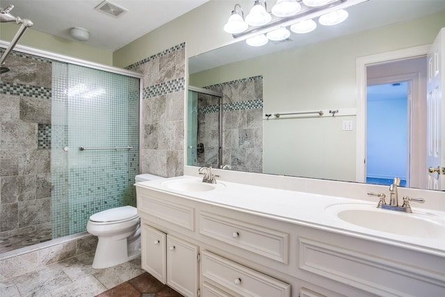 bathroom featuring vanity, an enclosed shower, and toilet