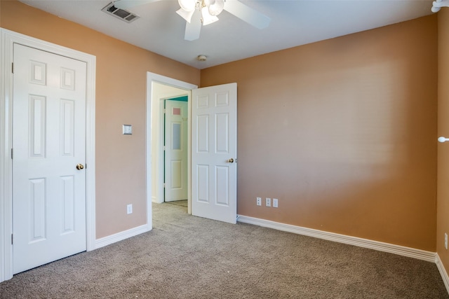 unfurnished bedroom featuring light colored carpet and ceiling fan