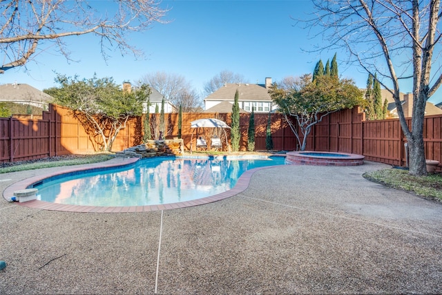 view of swimming pool featuring an in ground hot tub and a patio area