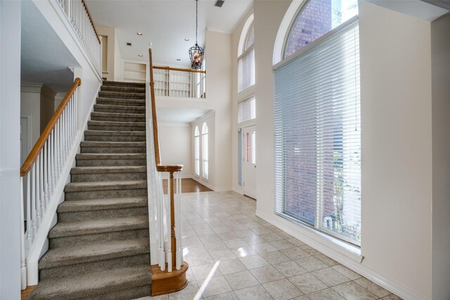 unfurnished living room with carpet, ceiling fan, a premium fireplace, and crown molding