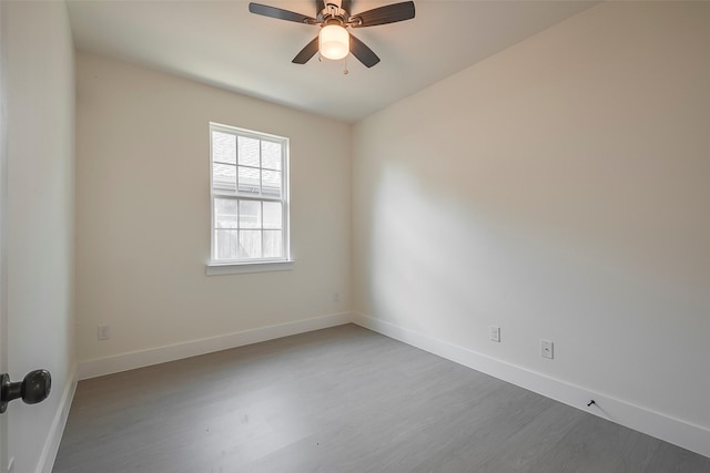 unfurnished room with ceiling fan and wood-type flooring