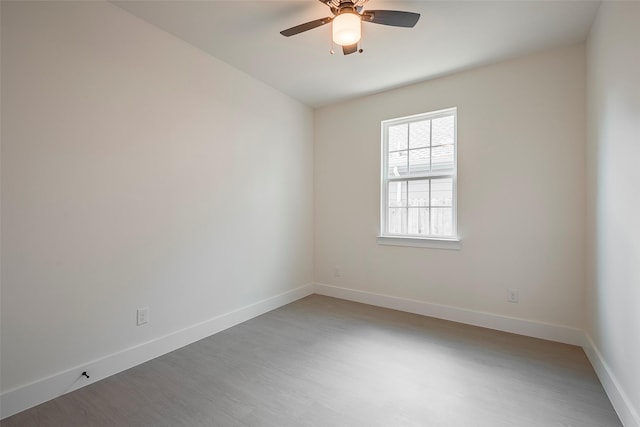 empty room featuring hardwood / wood-style flooring and ceiling fan