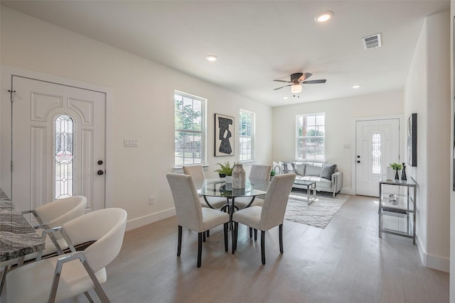 dining area featuring light hardwood / wood-style flooring and ceiling fan