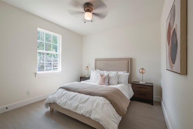 bedroom with light hardwood / wood-style flooring and ceiling fan