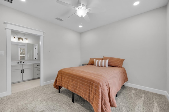 carpeted bedroom featuring ceiling fan and ensuite bathroom