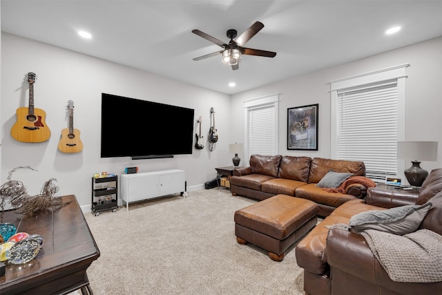 carpeted living room with ceiling fan