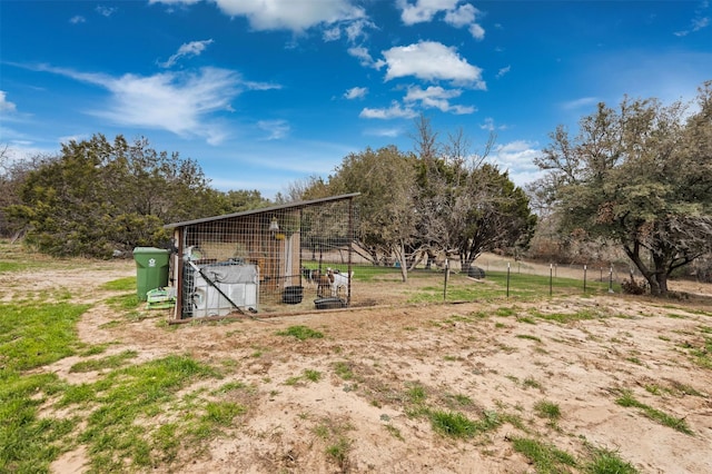 view of yard with a rural view and an outdoor structure