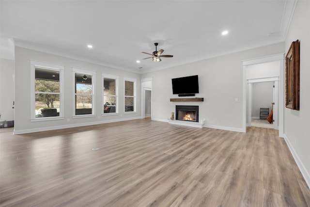 unfurnished living room featuring crown molding, ceiling fan, and light hardwood / wood-style flooring