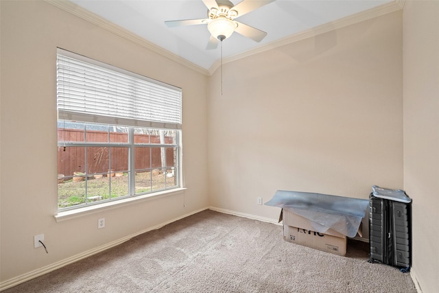 carpeted empty room with ceiling fan and ornamental molding