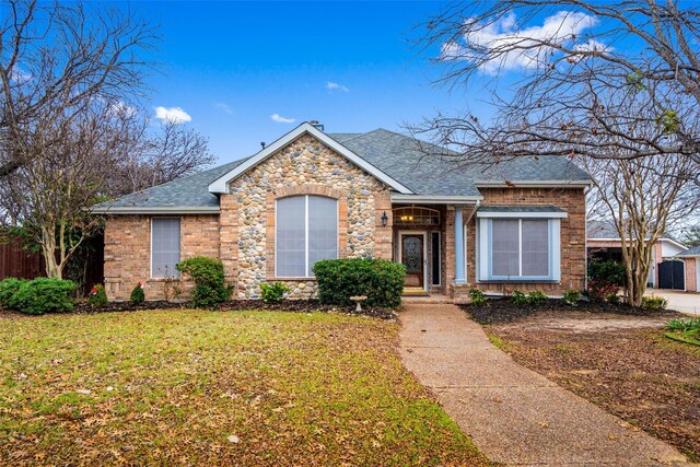 ranch-style house with a garage and a front yard