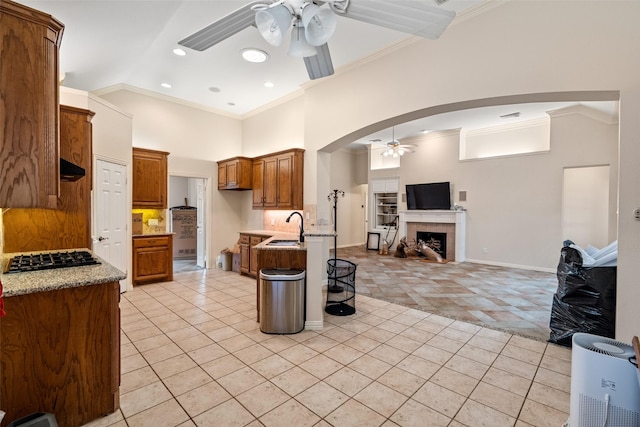 kitchen featuring light stone countertops, light tile patterned floors, white appliances, and ceiling fan