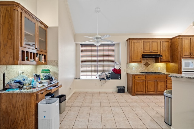 kitchen featuring lofted ceiling, crown molding, sink, ceiling fan, and stainless steel appliances