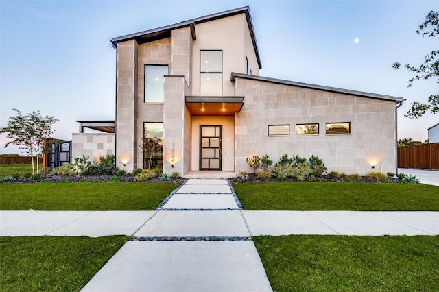 contemporary house featuring a front yard