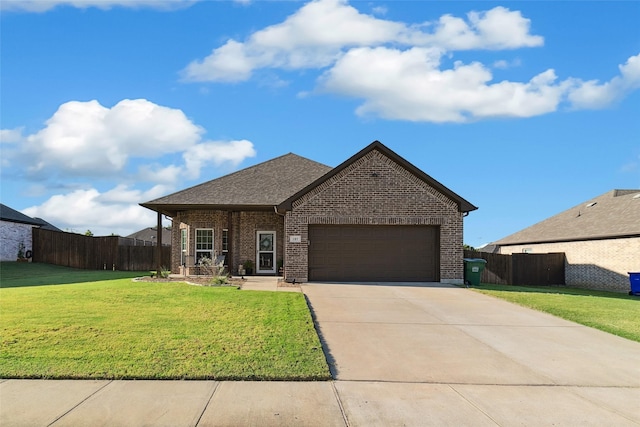 view of front of home with a front yard and a garage