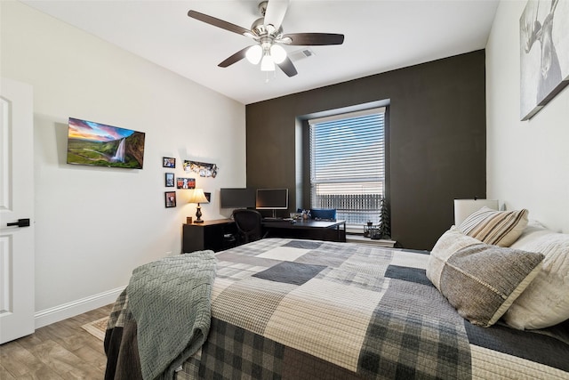 bedroom with wood-type flooring and ceiling fan