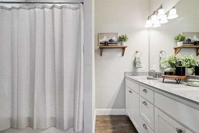 bathroom featuring a shower with shower curtain, vanity, and hardwood / wood-style floors