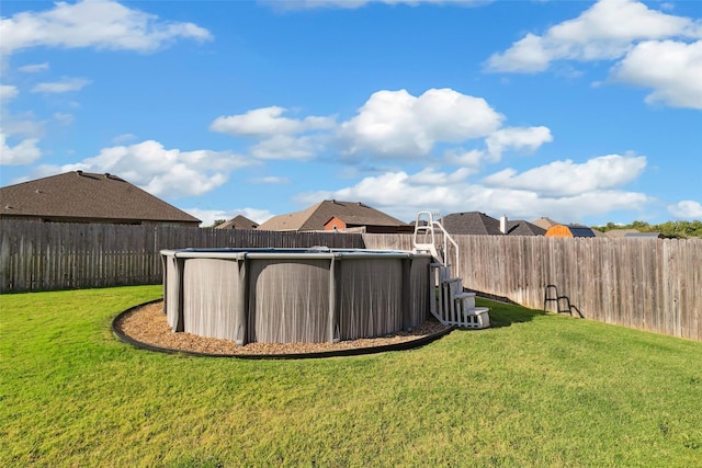 view of yard with a fenced in pool